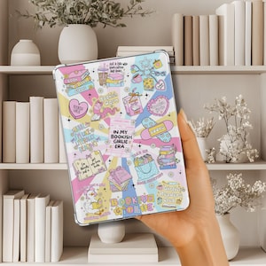 May include: A clear tablet case with a colorful, book-themed design. The case features various illustrations, including books, hearts, and the text "Bookish Girlie Era." The design incorporates pastel colors and whimsical elements.