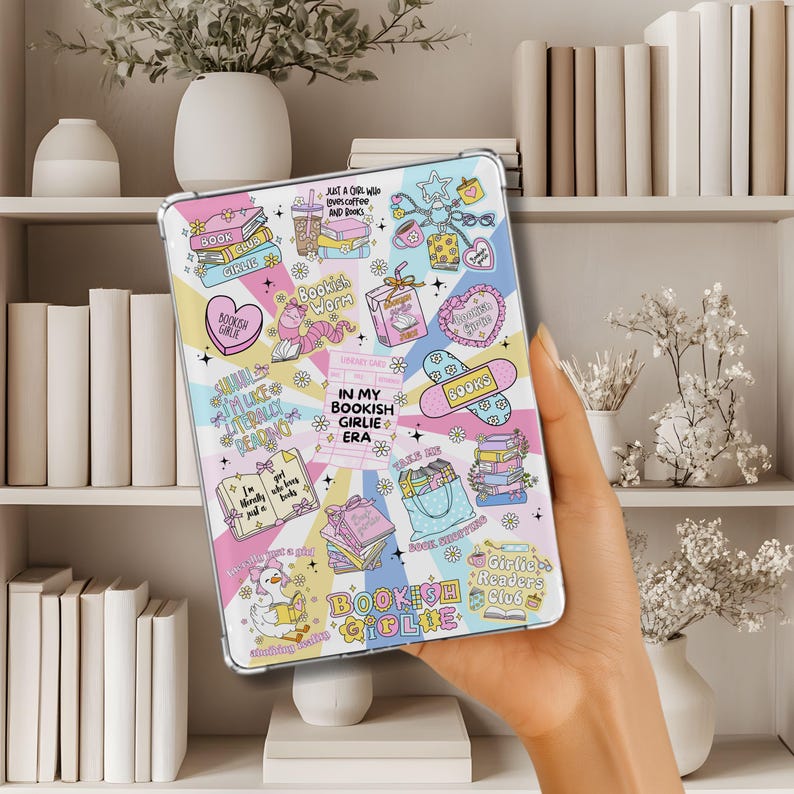 May include: A clear tablet case with a colorful, book-themed design. The case features various illustrations, including books, hearts, and the text "Bookish Girlie Era." The design incorporates pastel colors and whimsical elements.