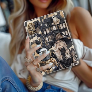 May include: A decorative tablet case featuring a spooky Halloween design. The case showcases a haunted house, a witch, black cats, and a ghost, all set against a leopard print background. The artwork is detailed and colorful, perfect for the fall season.