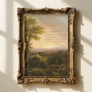 May include: A framed landscape print with a gold ornate frame. The artwork depicts a serene countryside scene with a tree, rolling hills, and a sunset. Text from Jeremiah 29:11 is printed on the artwork.