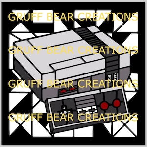 May include: A graphic illustration of a classic video game console and controller. The console is gray and black, with a matching controller featuring red and black buttons. The background is black with white geometric shapes, and the text "GRUFF BEAR CREATIONS" is repeated in yellow.