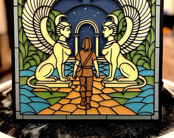 May include: A layered art piece depicting a person walking towards an archway between two sphinxes. The artwork features a night sky background with stars, and a colorful mosaic-style design with shades of blue, green, yellow, and brown.