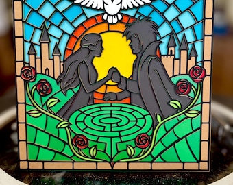 May include: A layered art piece depicting a couple holding hands in front of a yellow sun, with a maze, roses, and castle silhouettes. A white owl and dove are at the top, with a stained-glass style background of blue, orange, and green.