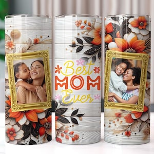 May include: Three stainless steel tumblers with floral designs and a photo of a mother and daughter. The tumblers have the text "Best Mom Ever" printed on them.