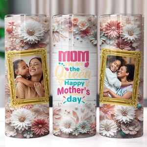 May include: A white tumbler with a floral design and the text "Mom you are the Queen Happy Mother's Day". The tumbler features a photo of a mother and daughter in a gold frame.