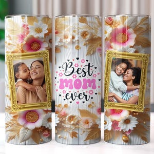 May include: Three stainless steel tumblers with white and gold floral designs. Each tumbler features a photo of two people in a gold frame. The text "Best Mom Ever" is printed in pink and black on the middle tumbler.