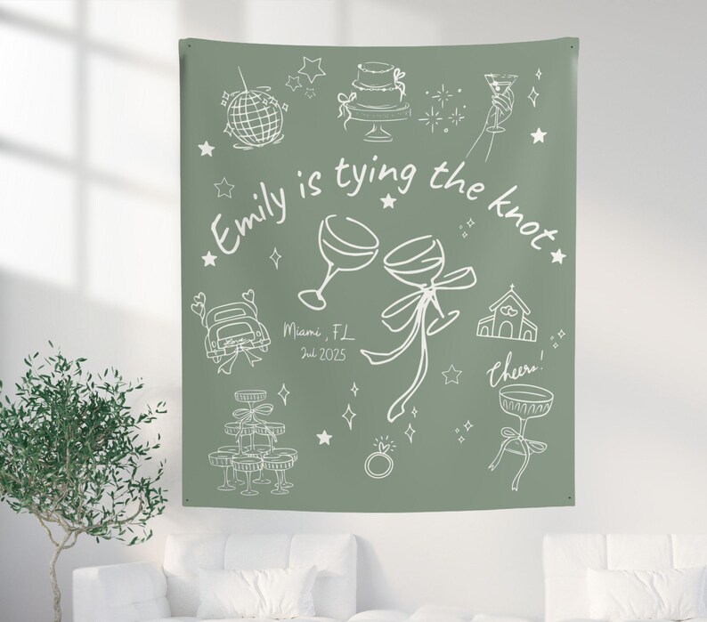 May include: Sage green tapestry with white line art illustrations of wedding-related icons, including a cake, champagne glasses, and a car. Text reads "Emily is tying the knot" with the date and location.