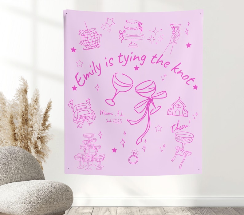 May include: A light pink tapestry with a hand-drawn design in a darker pink. The text "Emily is tying the knot" is featured, along with illustrations of a disco ball, cake, champagne glasses, and a wedding ring. The date "Jul 2025" is also included.