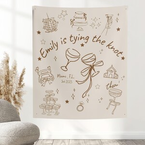 May include: Beige wedding tapestry with brown line art illustrations of wedding-related icons, including a cake, champagne glasses, and a car. Text reads "Emily is tying the knot" and "Miami, FL Jul 2025".