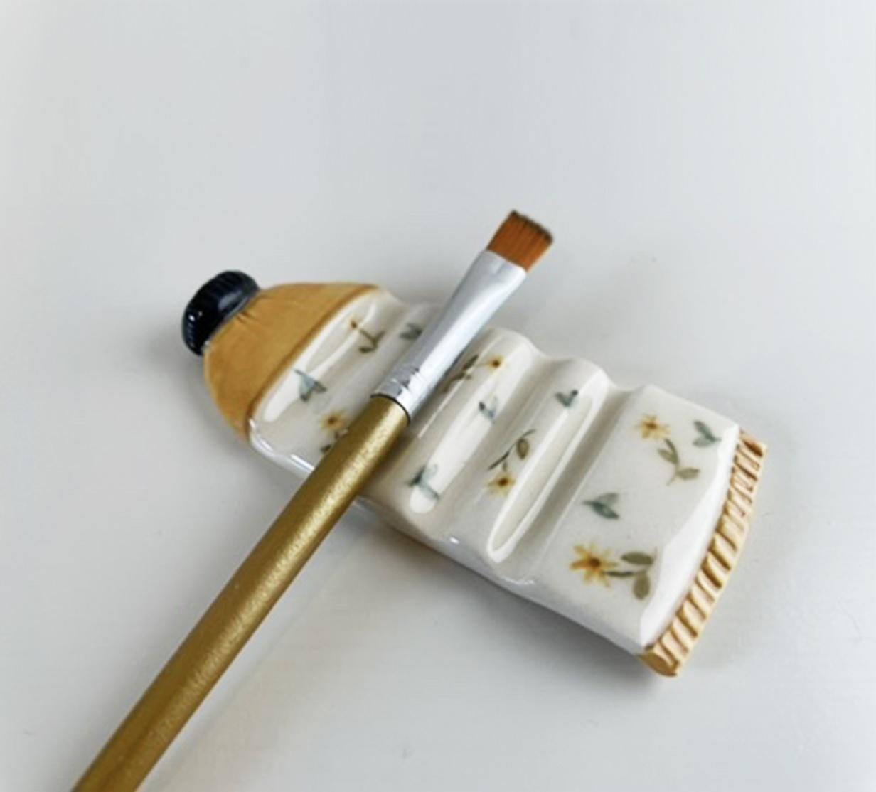 Unique Handmade Ceramic Brush Rest – Artist Paint Tube with Tiny Flower Accents, Pottery Gift for Artist, Gold