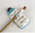 Handmade Ceramic Brush Rest: Paint Tube with Flower Accents