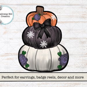May include: A stacked pumpkin decoration featuring an orange top pumpkin with a purple flower, a black middle pumpkin with a black bow and white flowers, and a white bottom pumpkin with purple flowers and green leaves, with text Galloway Hill Creation.
