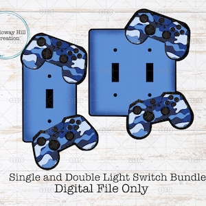 May include: Blue light switch covers with attached game controller designs. The controllers have a blue camouflage pattern. The image includes single and double light switch covers. Text at the bottom reads "Single and Double Light Switch Bundle Digital File Only."