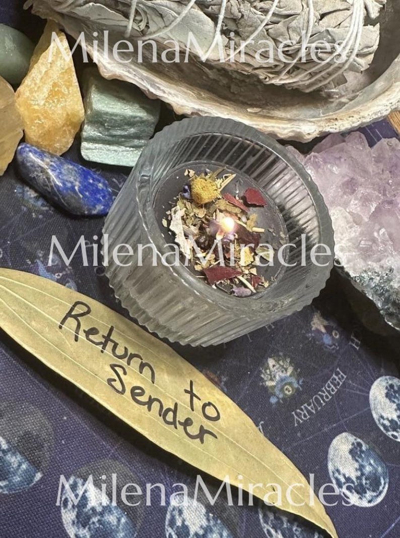 May include: A lit candle in a ribbed glass container, topped with dried herbs and petals. Beside it lies a dried leaf with the handwritten text 'Return to Sender'. The scene includes various crystals and a bundle of white sage in the background.