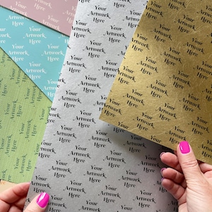 May include: A collection of patterned paper sheets in various colors, including pink, blue, green, silver, and gold. Each sheet features a repeating pattern of the text "Your Artwork Here".