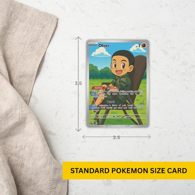 A visual sizing guide for a custom Pokémon-style card featuring a smiling child named Oliver. The card is displayed on a marble surface with measurement arrows showing its standard size: 2.5 by 3.5 inches. Yellow label at the bottom reads “Standard Pokémon Size Card.”