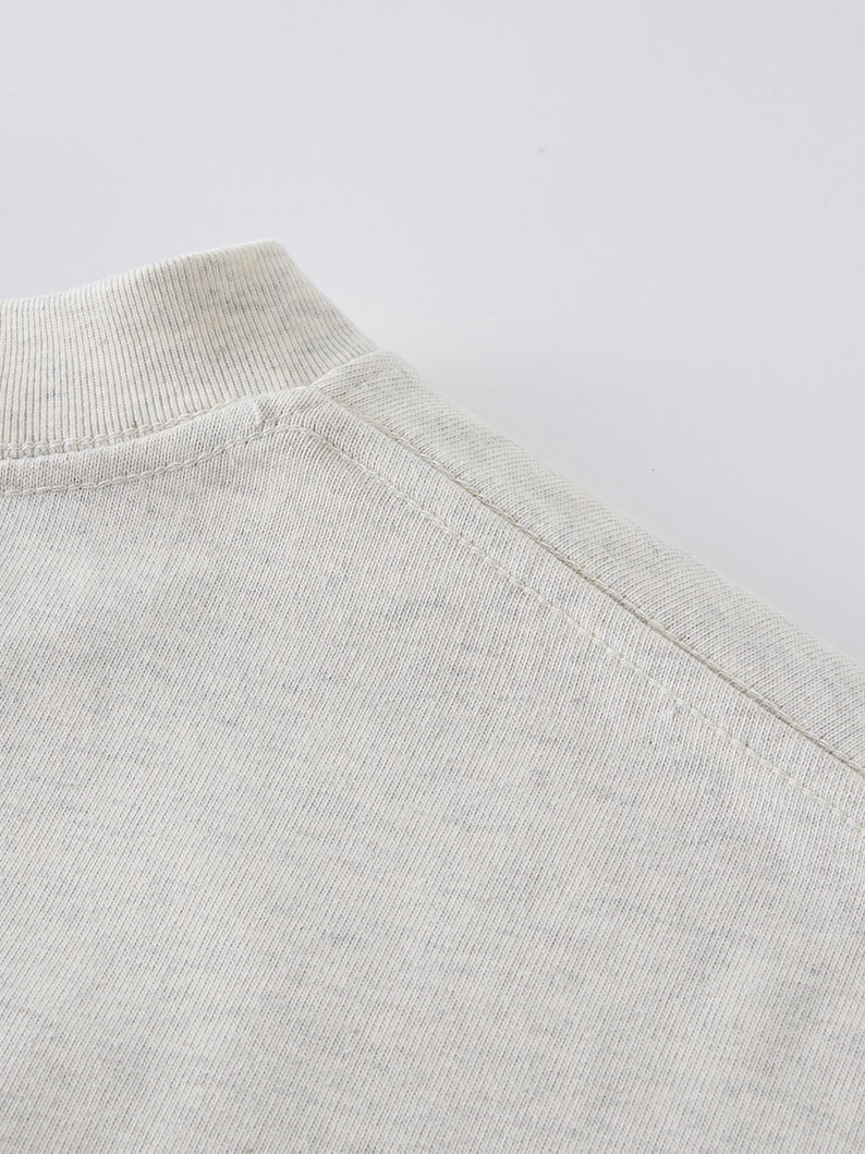 Heavyweight drop shoulder t-shirt size chart with unisex measurements, 425 GSM cotton details, care instructions, and fit guide.