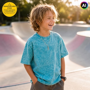 May include: A short-sleeved t-shirt in a mottled teal blue wash with a crew neckline. The shirt features a relaxed fit and is worn with a silver-toned chain necklace featuring a small pendant and a black wristwatch on the left wrist.