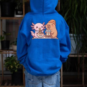 kid wearing royal blue Axolotl capybara kids hoodie kawaii ramen boba design