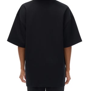 Heavyweight black drop shoulder t-shirt size chart with unisex measurements, 425 GSM cotton details, care instructions, and fit guide.