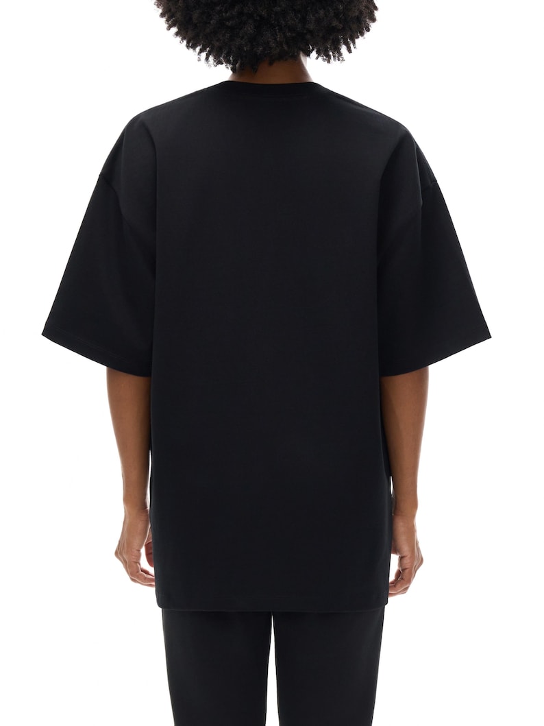 Heavyweight black drop shoulder t-shirt size chart with unisex measurements, 425 GSM cotton details, care instructions, and fit guide.