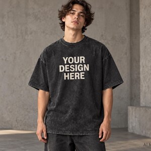 Model wearing a black custom acid wash oversized T-shirt with “Your Design Here” front print, heavyweight unisex streetwear tee.
