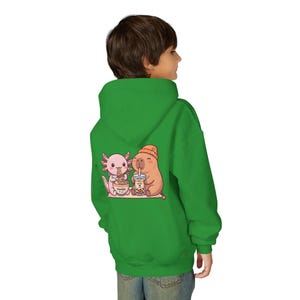 kid wearing irish green Youth hoodie white with cute axolotl and capybara design