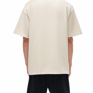 Heavyweight drop shoulder t-shirt size chart with unisex measurements, 425 GSM cotton details, care instructions, and fit guide.