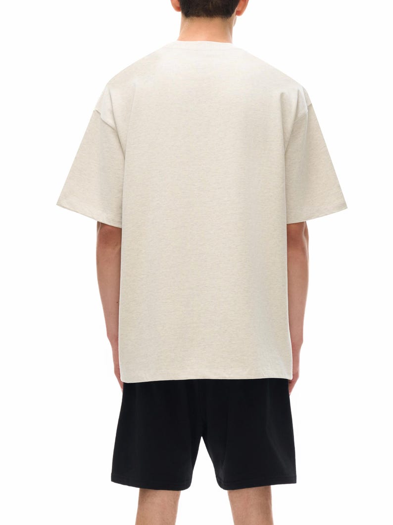 Heavyweight drop shoulder t-shirt size chart with unisex measurements, 425 GSM cotton details, care instructions, and fit guide.