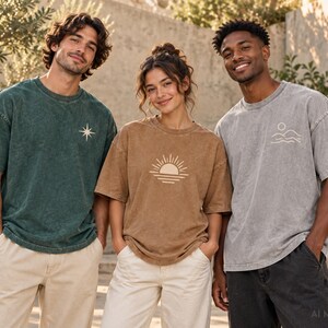 Three models wearing custom acid wash oversized T-shirts in dark green, light brown, and light gray with personalized printed graphics.
