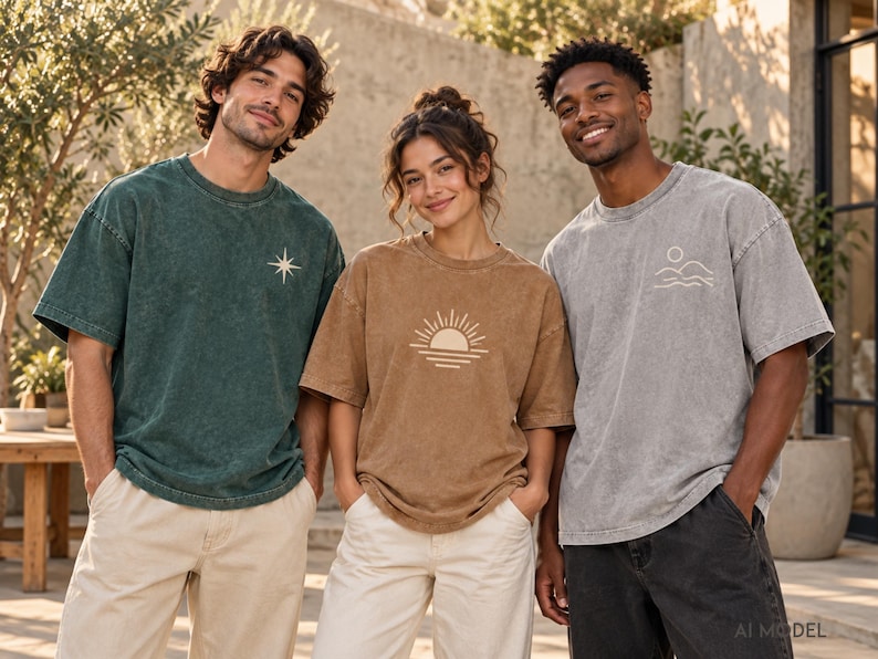 Three models wearing custom acid wash oversized T-shirts in dark green, light brown, and light gray with personalized printed graphics.