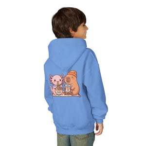 kid wearing Carolina blue Youth hoodie white with cute axolotl and capybara design