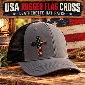 May include: A grey trucker hat with a black mesh back and a patch featuring a cross with a distressed American flag pattern. The text USA RUGGED FLAG CROSS LEATHERETTE HAT PATCH is visible above the hat in a wood-textured banner.