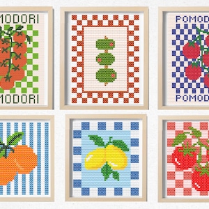 May include: Six framed cross-stitch artworks featuring food illustrations. The artworks depict tomatoes, olives, oranges, and lemons, with the word "POMODORI" in the top and bottom of the tomato artworks. Each piece has a unique patterned background.