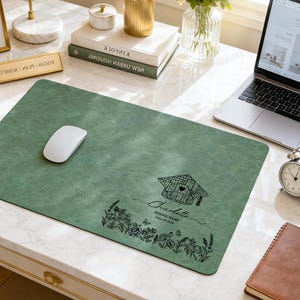 May include: A green desk mat with a white mouse. The mat features a graduation cap design, the name "Charlotte", and "School Name Class of 2026" in black script. Floral and butterfly illustrations are also present.