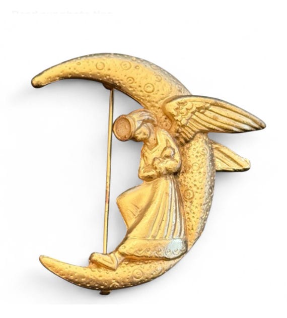 Angel sleeping on crescent moon