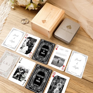 May include: A set of custom playing cards featuring black and white photographs and personalized text, including names like Jacob, Layla, Lucas, and Mia. The set includes a light wood box and a silver metal tin, both engraved with a spade symbol and names.