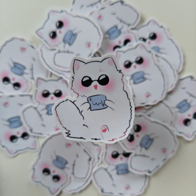 Cute anime cat sticker featuring a fluffy chibi-style Gojo Satoru design with sunglasses and a tiny cloth. A perfect Jujutsu Kaisen-themed vinyl sticker for fans to decorate water bottles, laptops, sketchbooks, and journals!