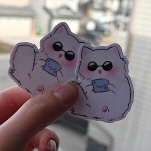 Cute Gojo-inspired cat sticker featuring a fluffy anime cat with dark sunglasses and a soft pastel design. Perfect for Jujutsu Kaisen fans, this vinyl sticker is great for decorating water bottles, laptops, notebooks, planners, and more.