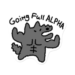 May include: A sticker featuring a cartoon wolf flexing its muscles. The wolf is gray with black outlines and has a muscular physique. The text "Going Full ALPHA" is written above the wolf in black, handwritten-style lettering.