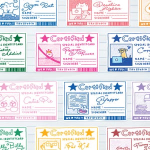 May include: A collection of rectangular stickers featuring various 'Certified Special Identity Card' designs in different colours. Each card includes a character illustration, a title such as 'Passenger Princess' or 'Yapper', and blank lines for a name and signature.