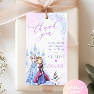 May include: A gift box with a light pink ribbon and a tag that says "Thank You." The tag features illustrations of two princesses, a castle, and a snowman. The text on the tag reads "snow much for making my birthday so CHILLIN!" and "Charlotte."
