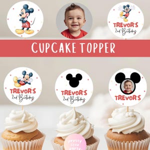 May include: Cupcake toppers featuring Mickey Mouse illustrations and a child's photo. The toppers are round with a white background, red and yellow accents, and the text "Trevor's 2nd Birthday". The image also includes cupcakes.