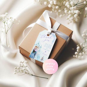 May include: A brown gift box with a white ribbon and a custom tag. The tag has a watercolor illustration of two characters and the words "thank you". A pink sticker with the text "pretty little party" is also visible.