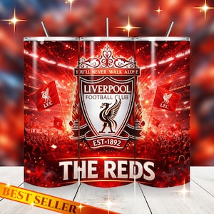 May include: A red and white tumbler featuring the Liverpool Football Club crest, a black bird on a shield, and the text "YOU'LL NEVER WALK ALONE." The design includes the words "THE REDS" and "EST-1892."