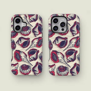 May include: Two phone cases with a repeating pattern of red and navy blue seashells on a cream background. The shells are detailed with white line art, creating a vintage, nautical aesthetic. The cases are designed for a smartphone.