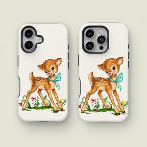 May include: Two white phone cases with a vintage illustration of a fawn. The fawn is brown with white spots, a blue bow, and is standing in a field of flowers. The phone cases have black side accents and camera cutouts.