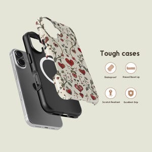 May include: An exploded view of a phone and phone case. The case is white with a floral and heart pattern. The phone is silver and black. The text "Tough cases" is visible, along with icons for features like "Shake proof" and "Excellent Grip".