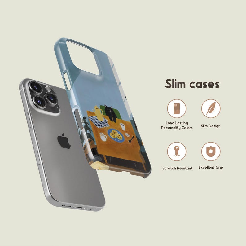 以下が含まれることがあります： シルバーのiPhoneと透明なスマホケース。ケースには、猫、黄色のティーポット、食べ物のプレートが描かれたカラフルなテーブルセッティングのイラストが描かれています。「Slim cases」というテキストが表示されています。
