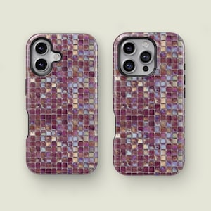 May include: Two phone cases with a mosaic tile design. The cases are covered in small, square tiles in shades of purple, pink, and gold. The cases have cutouts for the phone's camera and buttons.